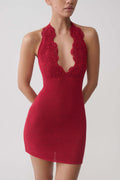 Woman wearing a red crochet halter mini dress.