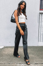Black PU pants featuring a silver button closure and visible fly stitching