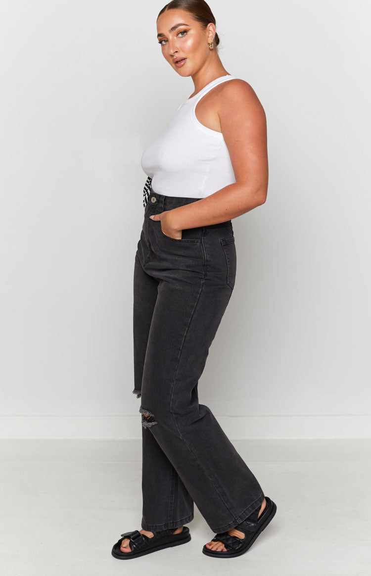 Black wash wide leg denim jeans with ripped knees and a high waist