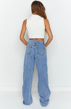 Rear view of light blue wide-leg jeans showing back pockets, belt loops, and a relaxed fit