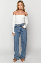 Blue wide-leg jeans with a distinctive uneven crossover waist and relaxed fit