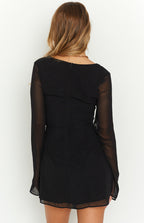 Close-up of the black mini dress side tie detail creating an adjustable slit and subtle ruching