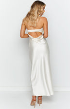 Rear view of a white satin maxi dress featuring a low open back and a ruched elastic strap