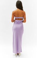 Rear view of a lilac strapless maxi dress with a shirred elastic back and a draped cutout detail