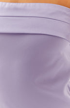 Close-up of the textured lilac fabric with a horizontal folded band detail on the maxi dress