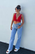 Full length view of blue wide-leg jeans with a relaxed fit and an uneven waistline