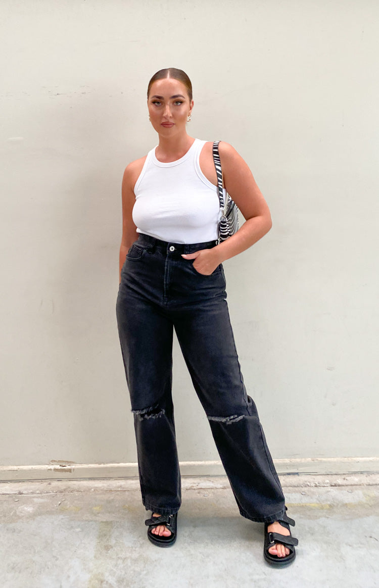 Washed black high-waisted wide-leg jeans with distressed knee rips
