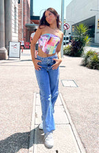 Light blue wide-leg jeans with an uneven crossover waist and relaxed fit
