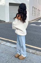 Side view of light blue wide-leg jeans with a relaxed fit and frayed hem