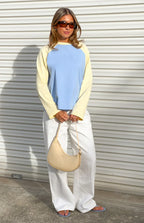 Blue and yellow long sleeve raglan top with a round neck and relaxed fit