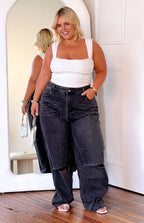 Black wash wide leg jeans with ripped knees and a high waist