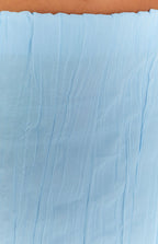 Rear view of a light blue crinkled maxi skirt with a straight fit