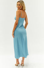 Side-back view of a blue satin maxi dress with thin adjustable straps and a flowing, bias-cut skirt